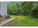 Lush green backyard with mature trees and a wooden fence at 5144 Pinehall Wynd, Raleigh, NC 27604