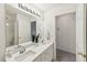 Bright bathroom showcasing double sinks, quartz counters, and ample storage at 5144 Pinehall Wynd, Raleigh, NC 27604