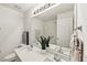 Bathroom features a double sink vanity with quartz countertops and ample lighting at 5144 Pinehall Wynd, Raleigh, NC 27604