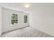 Comfortable bedroom with plush carpet and two windows providing natural light at 5144 Pinehall Wynd, Raleigh, NC 27604