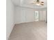 Bright bedroom with neutral carpet, ceiling fan, and ensuite bathroom view at 5144 Pinehall Wynd, Raleigh, NC 27604