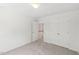 Bedroom featuring carpeted floors and a closet, leading to the stairs at 5144 Pinehall Wynd, Raleigh, NC 27604