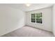 Comfortable bedroom featuring plush carpet, a bright window, and neutral colored walls at 5144 Pinehall Wynd, Raleigh, NC 27604