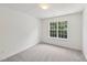 Cozy bedroom featuring soft carpet, a light and bright window, and neutral walls at 5144 Pinehall Wynd, Raleigh, NC 27604