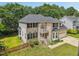 Brick house with a white balcony above the entry, a well-manicured lawn, and mature trees at 5144 Pinehall Wynd, Raleigh, NC 27604