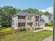 Exterior shot of a brick and vinyl two story house with well-manicured landscaping at 5144 Pinehall Wynd, Raleigh, NC 27604