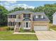 Stately two-story brick home with manicured lawn and a two-car garage at 5144 Pinehall Wynd, Raleigh, NC 27604