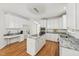 Well-lit kitchen featuring white cabinets, granite countertops and stainless steel appliances at 5144 Pinehall Wynd, Raleigh, NC 27604