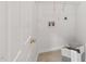 Clean and functional laundry room with white walls, wood-look flooring, and a laundry basket at 5144 Pinehall Wynd, Raleigh, NC 27604