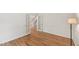 Open living room with hardwood floors, white trim and french doors leading to a staircase at 5144 Pinehall Wynd, Raleigh, NC 27604