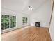 Spacious living room with hardwood floors, large windows, and a fireplace at 5144 Pinehall Wynd, Raleigh, NC 27604