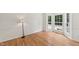 Light filled living room boasts hardwood floors, white trim and large windows with an inviting view at 5144 Pinehall Wynd, Raleigh, NC 27604