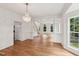 Spacious living room with hardwood floors, columns, and large windows providing ample natural light at 5144 Pinehall Wynd, Raleigh, NC 27604