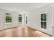 Inviting living room featuring beautiful hardwood floors, white trim and multiple bright windows at 5144 Pinehall Wynd, Raleigh, NC 27604