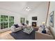 Bright living room with fireplace, large windows, and comfortable seating arrangement at 5144 Pinehall Wynd, Raleigh, NC 27604