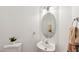 Cozy powder room with pedestal sink, decorative mirror, and stylish fixtures at 5144 Pinehall Wynd, Raleigh, NC 27604