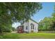 View of the rear exterior featuring a screened porch and red stairs at 5144 Pinehall Wynd, Raleigh, NC 27604