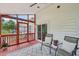 Relaxing screened porch with patio furniture and an outdoor ceiling fan at 5144 Pinehall Wynd, Raleigh, NC 27604