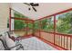 Cozy screened porch with chairs and ceiling fan, perfect for outdoor relaxation at 5144 Pinehall Wynd, Raleigh, NC 27604