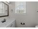 Bathroom with a vanity, a window and modern fixtures at 5301 Tilford Ln, Raleigh, NC 27613