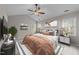 Cozy bedroom featuring a decorative ceiling fan and bright windows at 5301 Tilford Ln, Raleigh, NC 27613