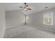 Spacious bedroom with a ceiling fan and multiple bright windows at 5301 Tilford Ln, Raleigh, NC 27613