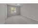Bedroom with neutral walls, carpet, and a bright window at 5301 Tilford Ln, Raleigh, NC 27613