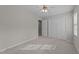 Neutral bedroom with carpet, ceiling fan, and ample closet space at 5301 Tilford Ln, Raleigh, NC 27613