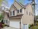A two-story home showcasing neutral siding, black shutters, and a two-car garage at 5301 Tilford Ln, Raleigh, NC 27613