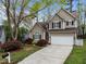 Charming two-story home with a well-manicured lawn, featuring a two-car garage and neutral-colored siding at 5301 Tilford Ln, Raleigh, NC 27613