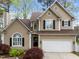 Charming home with tan siding, black shutters, and manicured landscaping adding curb appeal at 5301 Tilford Ln, Raleigh, NC 27613