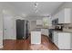 Functional kitchen with stainless steel appliances, center island and hardwood flooring at 5301 Tilford Ln, Raleigh, NC 27613