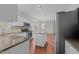Kitchen with a center island and stainless steel appliances, next to a dining area at 5301 Tilford Ln, Raleigh, NC 27613