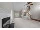 Spacious living room featuring a cozy fireplace and staircase access to upper levels at 5301 Tilford Ln, Raleigh, NC 27613