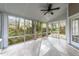 Bright and airy sunroom with tiled flooring and panoramic views of the backyard at 5301 Tilford Ln, Raleigh, NC 27613