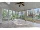 Bright sunroom featuring a ceiling fan and many large windows providing natural light and views of the outdoors at 5301 Tilford Ln, Raleigh, NC 27613