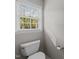 Toilet positioned next to a bright window at 5301 Tilford Ln, Raleigh, NC 27613