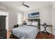 Cozy bedroom featuring a ceiling fan, hardwood floors, and a neutral color scheme for a calming retreat at 605 Smedes Pl # A, Raleigh, NC 27605