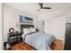 Well-lit bedroom featuring hardwood floors, ceiling fan, and stylish décor for a relaxing space at 605 Smedes Pl # A, Raleigh, NC 27605