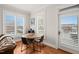 Bright dining area featuring a round wooden table, seating for four, and shuttered windows at 605 Smedes Pl # A, Raleigh, NC 27605