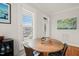 Cozy dining area with a round wooden table and shuttered windows overlooking the cityscape at 605 Smedes Pl # A, Raleigh, NC 27605