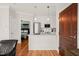 The kitchen features white cabinets, marble counters, and stainless appliances, as well as a view into the bedroom at 605 Smedes Pl # A, Raleigh, NC 27605