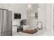 A well-lit kitchen features stainless steel appliances, marble countertops, and a modern sink and faucet at 605 Smedes Pl # A, Raleigh, NC 27605