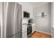 Modern kitchen features stainless steel appliances, white cabinetry, marble backsplash, and an electric cooktop at 605 Smedes Pl # A, Raleigh, NC 27605