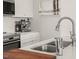 Modern kitchen with stainless steel sink and faucet, marble counters, and contemporary art at 605 Smedes Pl # A, Raleigh, NC 27605