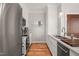 Contemporary kitchen with stainless steel appliances, white cabinets, hardwood floors, and sleek marble countertops at 605 Smedes Pl # A, Raleigh, NC 27605