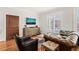 Well-appointed living room boasts shuttered windows, hardwood floors, leather furniture, and a rustic wood dresser at 605 Smedes Pl # A, Raleigh, NC 27605