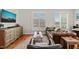 Inviting living room with leather furniture, rustic wood accents, hardwood floors and shuttered windows at 605 Smedes Pl # A, Raleigh, NC 27605