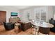 Open-concept living area combines a leather sofa and a dining table set, featuring hardwood floors at 605 Smedes Pl # A, Raleigh, NC 27605