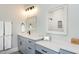 A neutral-toned bathroom features a vanity with a sink and a decorative mirror at 6480 Beaver Creek Rd, New Hill, NC 27562